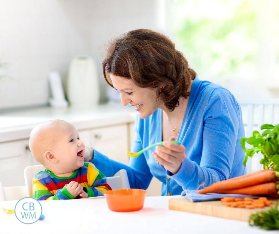 Mom feeding baby solid foods