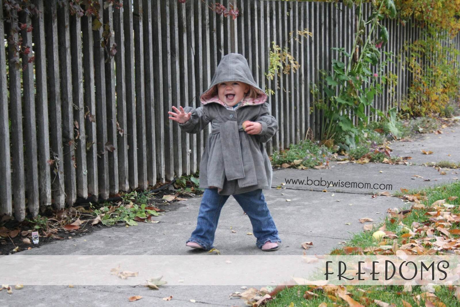 Toddler walking down the sidewalk