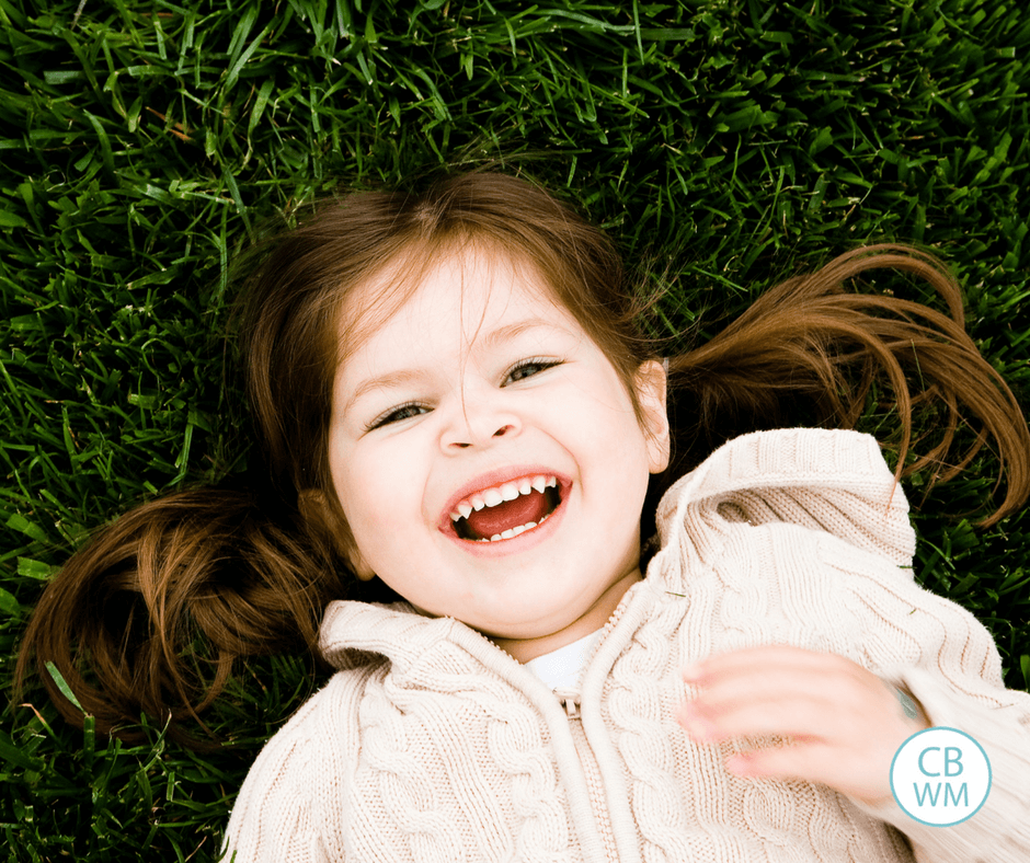 Toddler girl on grass happy and smiling