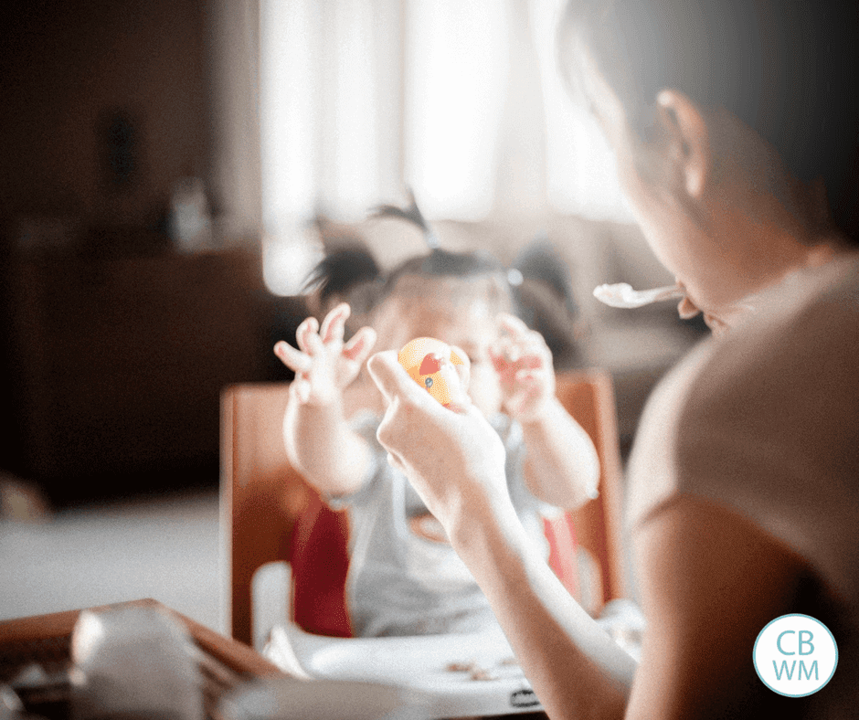 parent feeding a baby