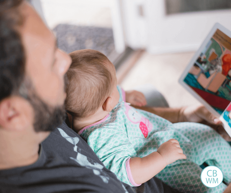 A dad reading to his baby