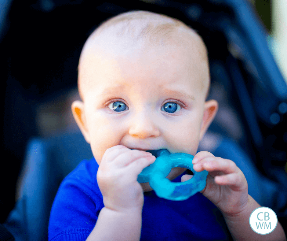 baby chewing on teething toy