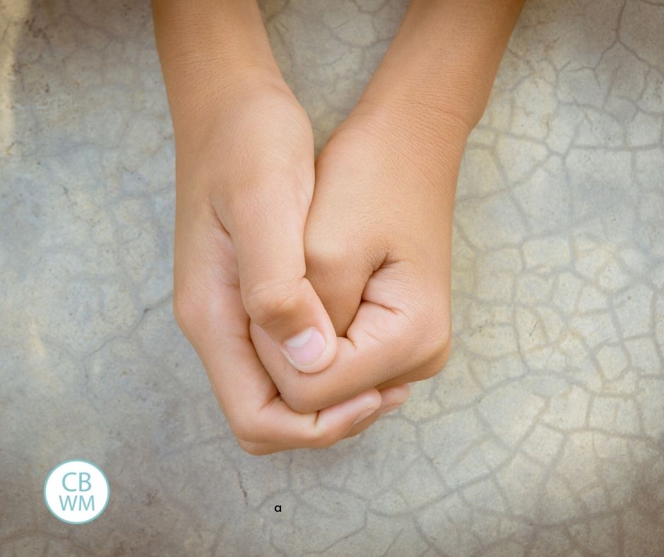 child folding hands