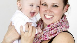 mom and baby smiling for the camera