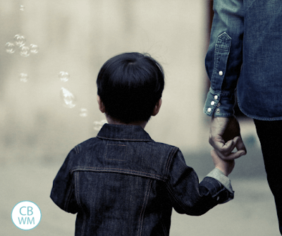 Child walking holding parent's hand