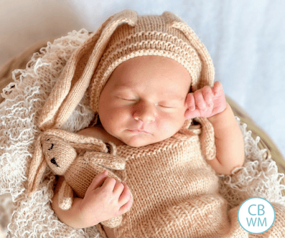 Newborn baby sleeping wearing a crocheted bunny costume