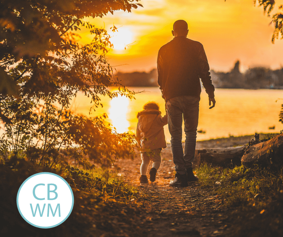 Parent and child walking into the sunset