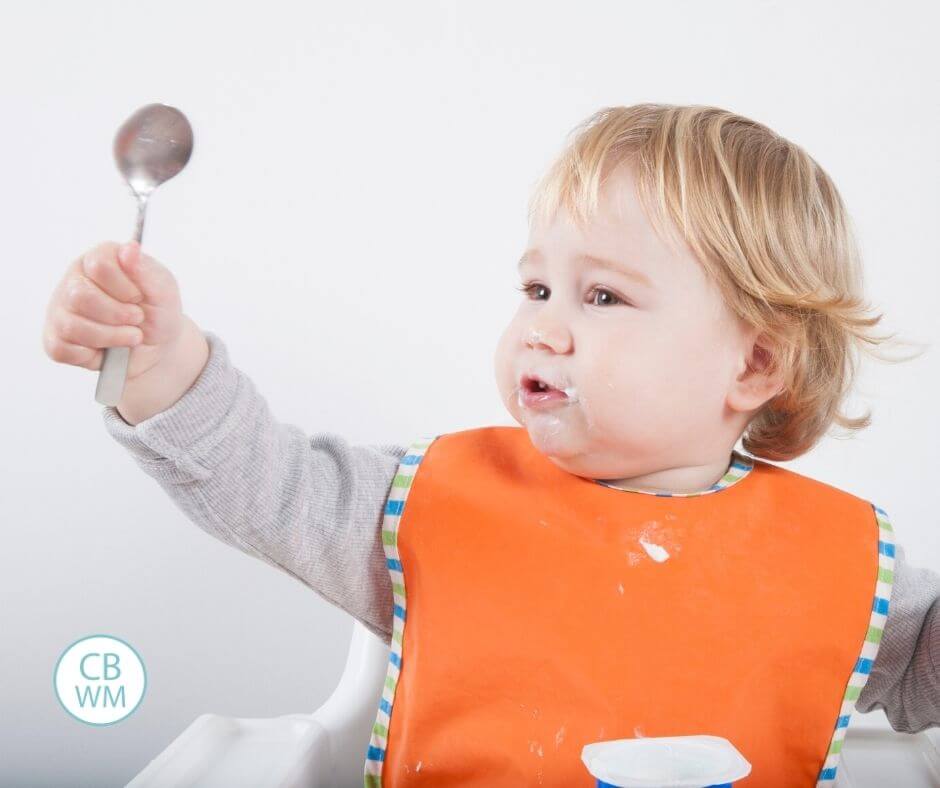 Toddler eating with a spoon