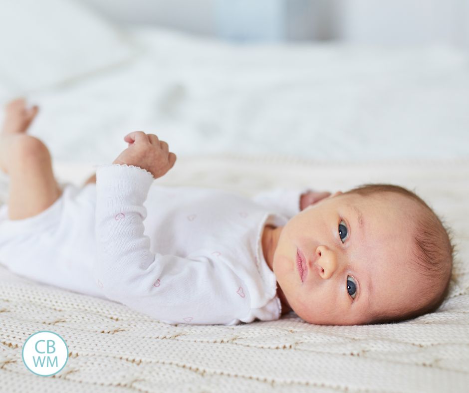 Baby in bed looking at camera