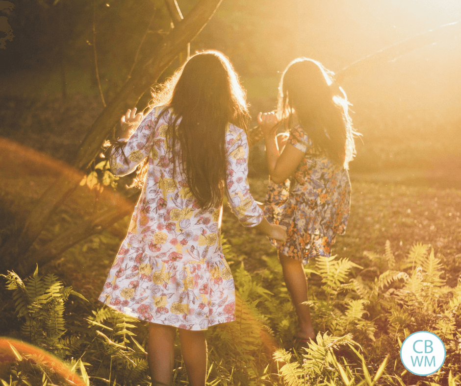 Mother and daughter walking with their backs to the camera