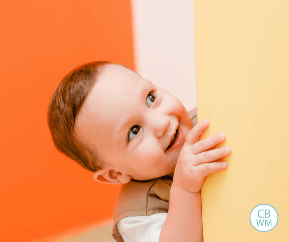 Older baby peeking around the corner