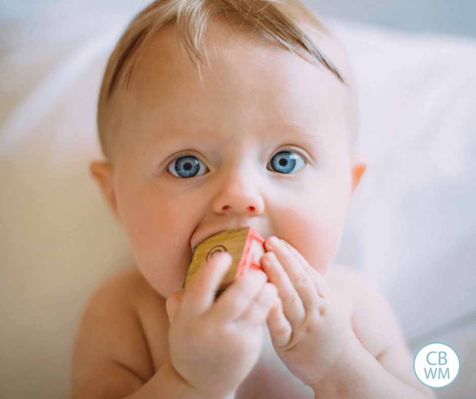 Baby sucking on a block