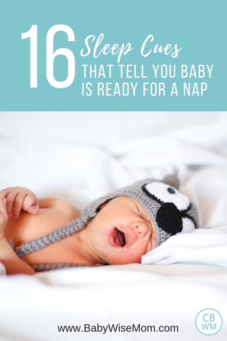 16 Sleep Cues that tell you baby is ready for a nap with a picture of a sleeping baby on white bedding