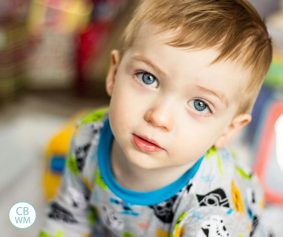 Toddler boy with blue eyes looking at the camera.