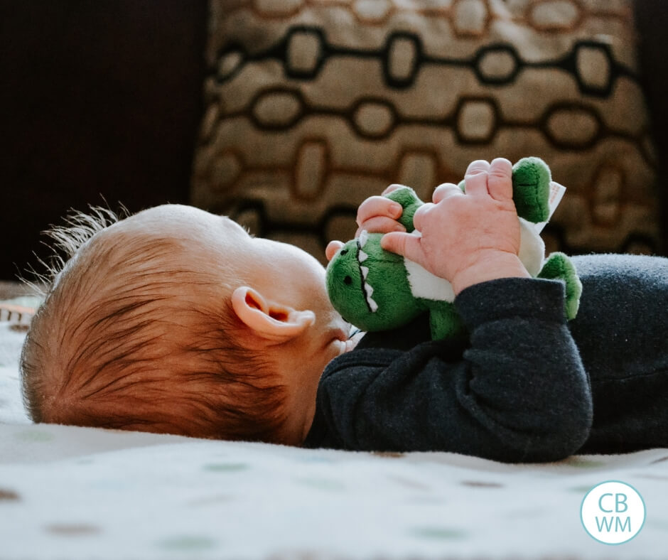 Newborn baby with a toy