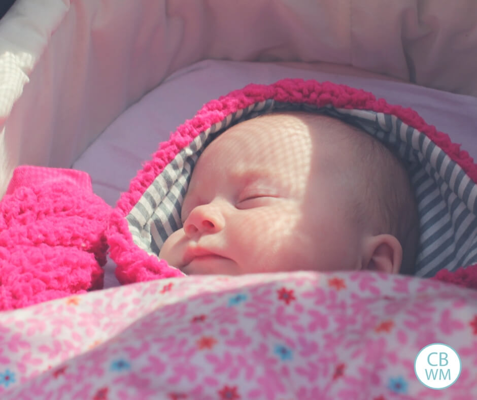 Newborn baby sleeping in bassinet