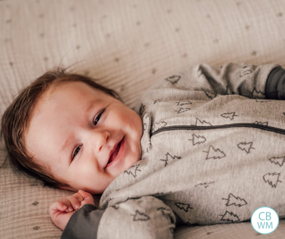 Smiling baby lying in a bed