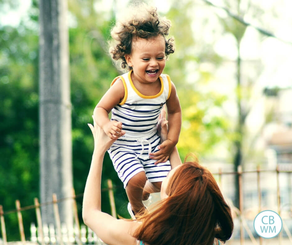 Mom tossing her toddler into the air