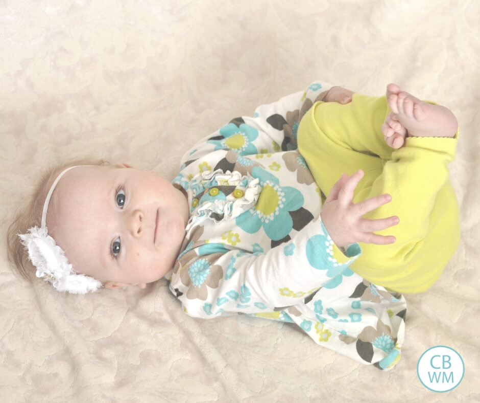 Baby lying on the ground and looking at the camera