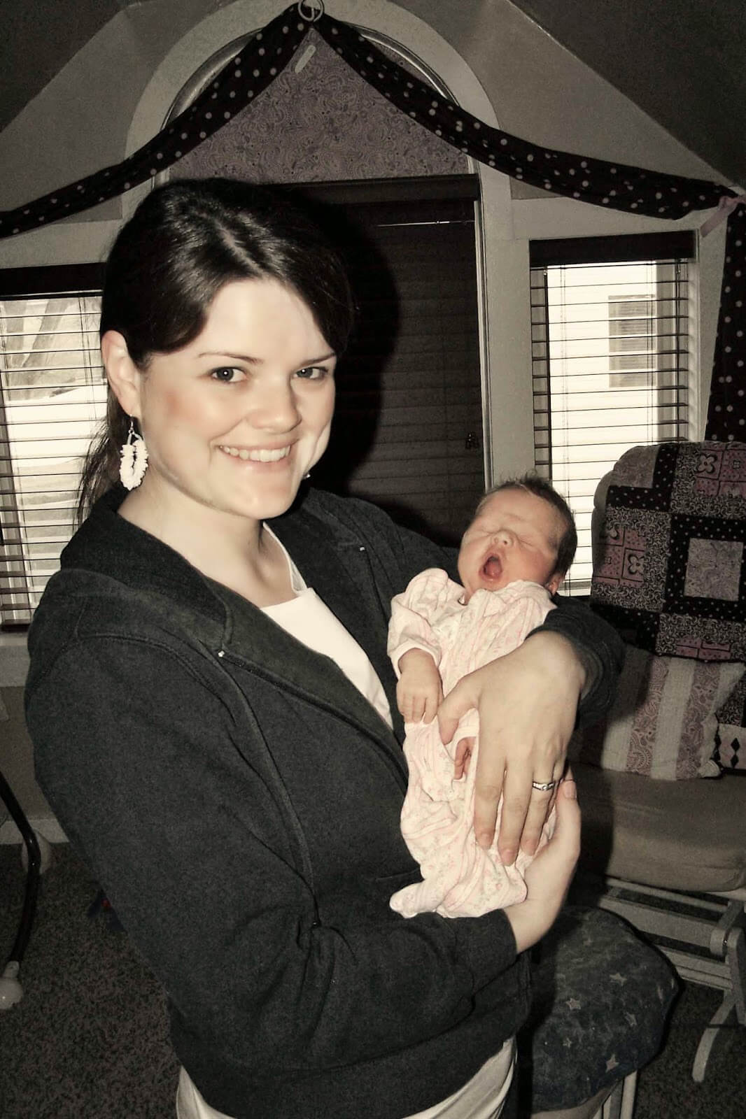 mom holding newborn girl