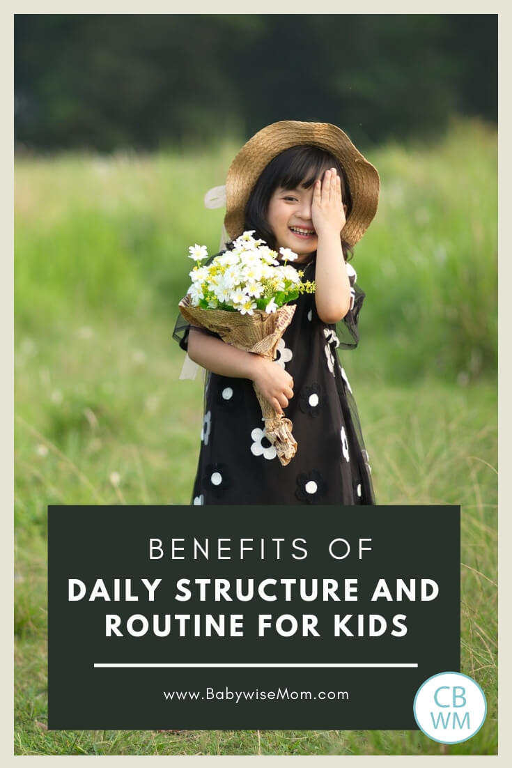 Girl standing in a green meadow holding flowers with a text overlay reading benefits of structure and routine for kids