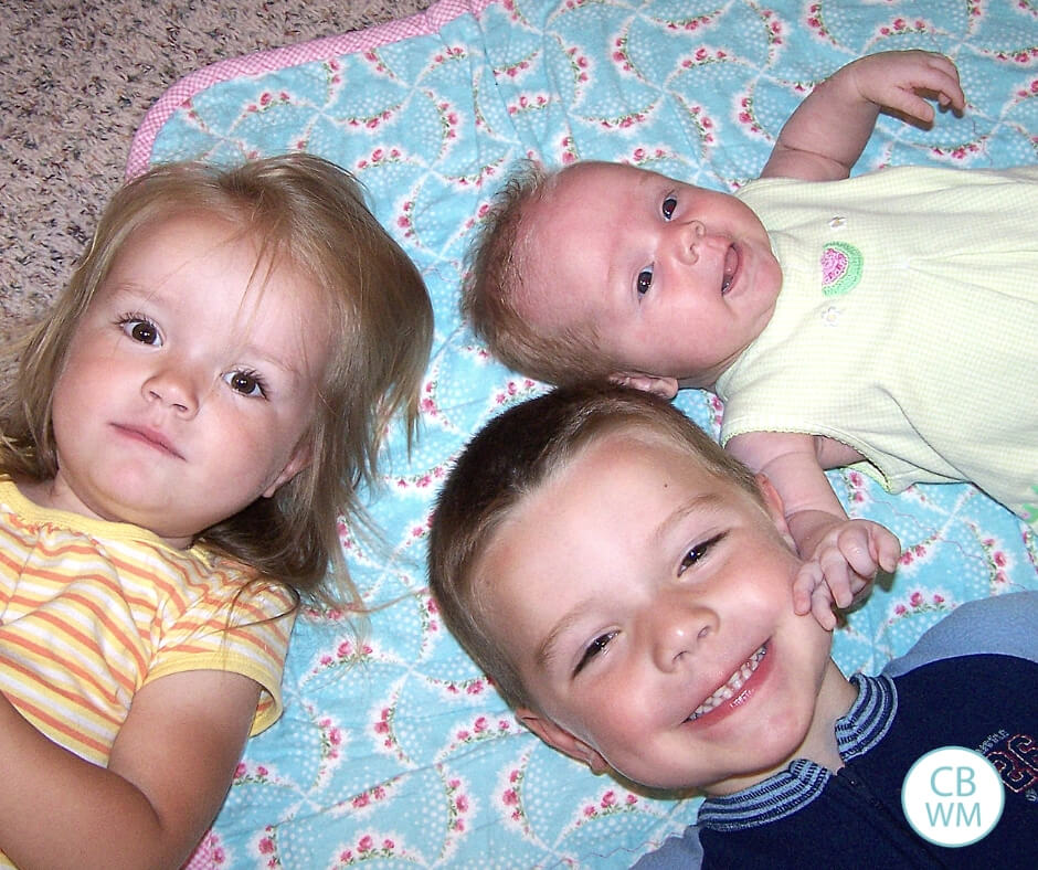 Three children on the ground. One boy and two girls.