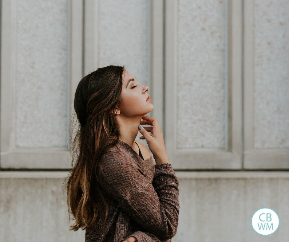 Woman standing with her eyes closed