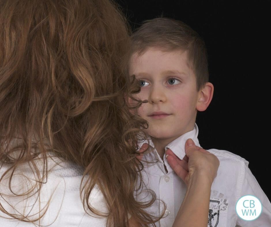 Mom checking son's collar