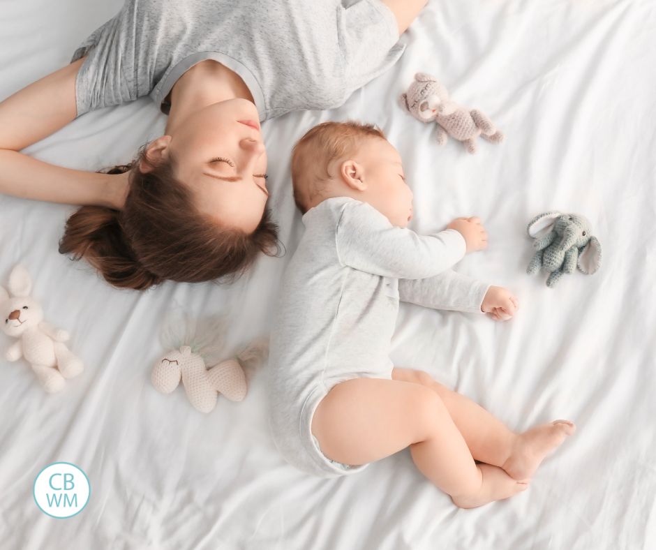 Mom and baby snoozing on the bed