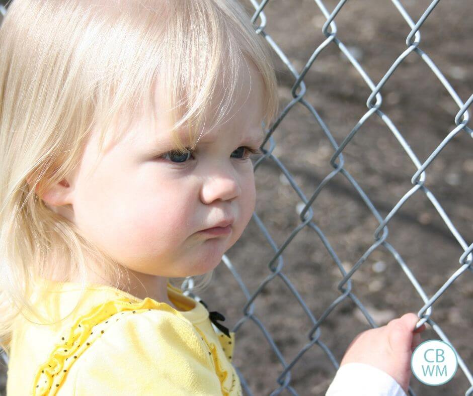 Girl standing at fence