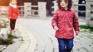 Two children on a cobblestone path