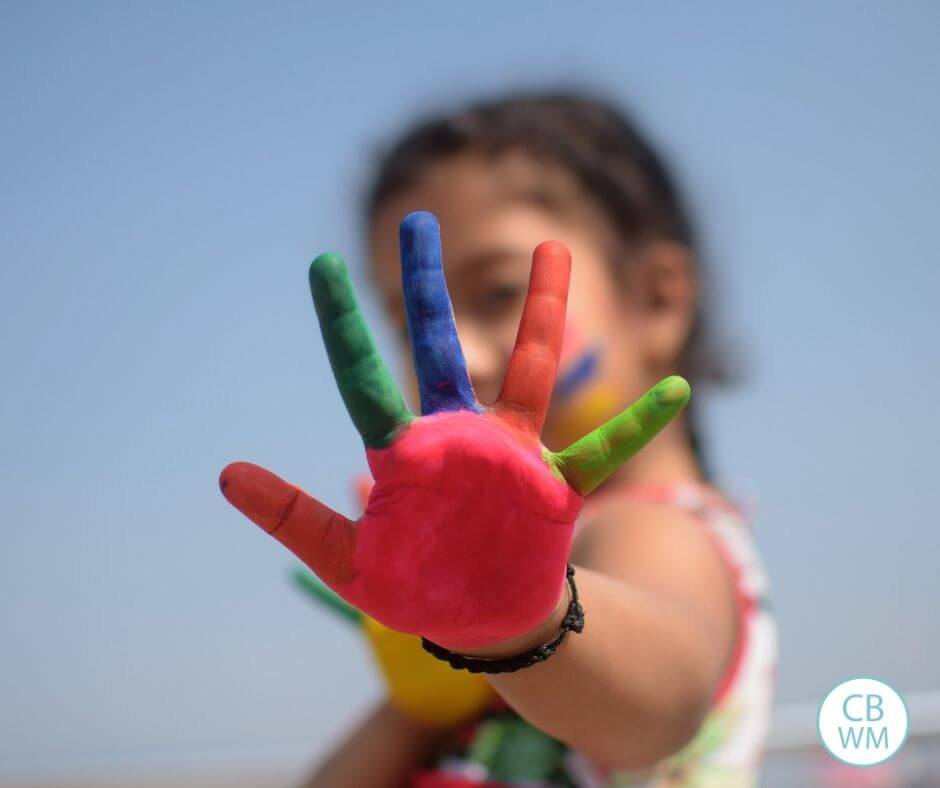 Girl holding up a painted hand