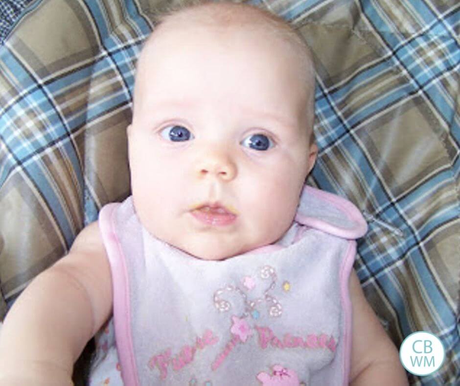 25 week old baby McKenna sitting in a high chair