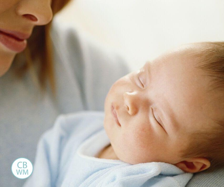 Baby sleeping in mom's arms