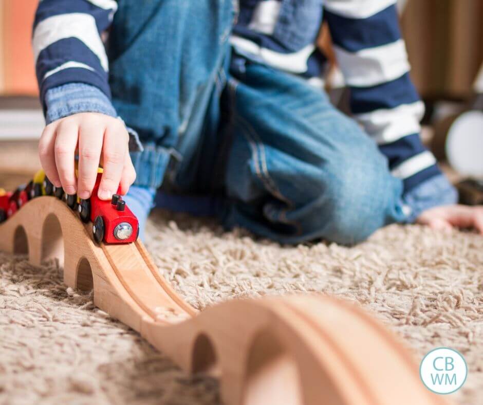 Toddler playing with train set