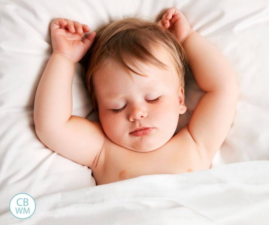 Sleeping baby on white linens