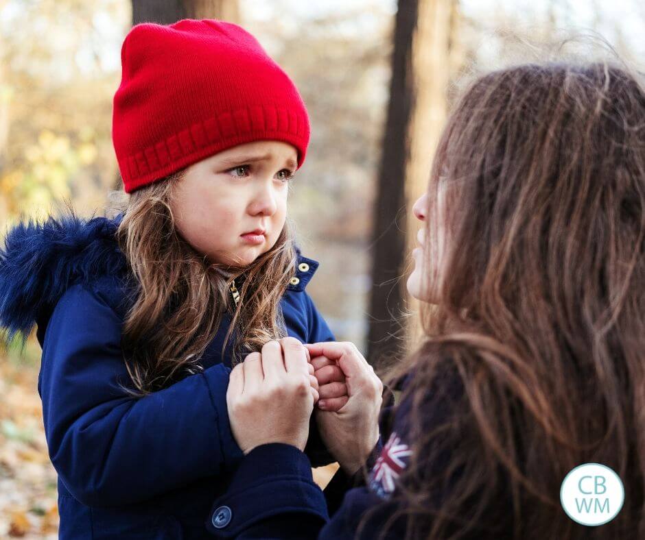 Scared preschooler talking with her mom