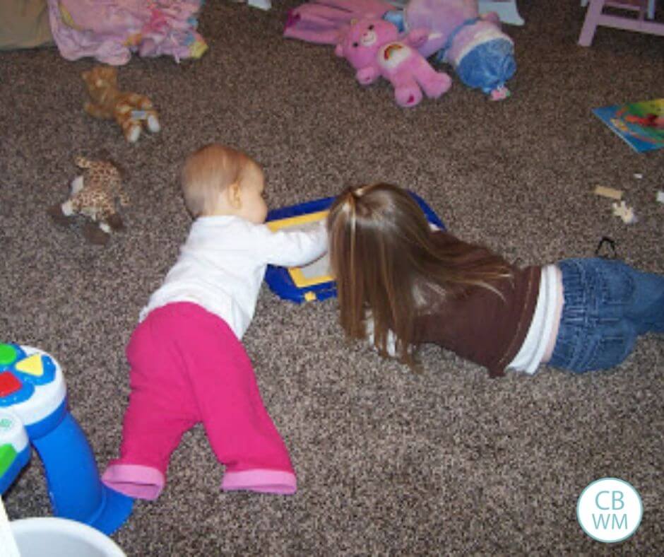 45 week old baby and her sister playing