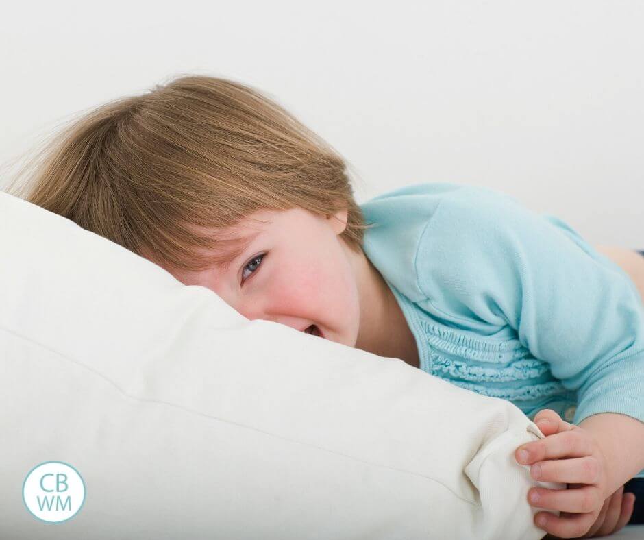 Crying toddler with face in a pillow