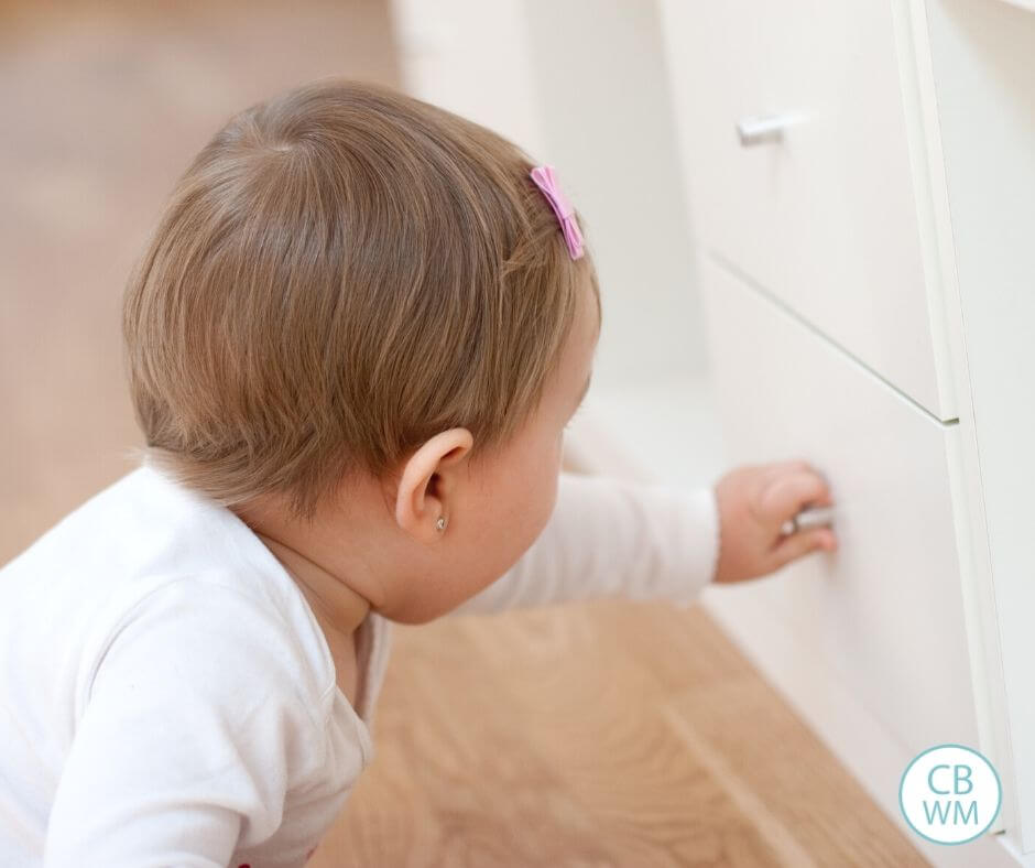 Baby reaching for a drawer