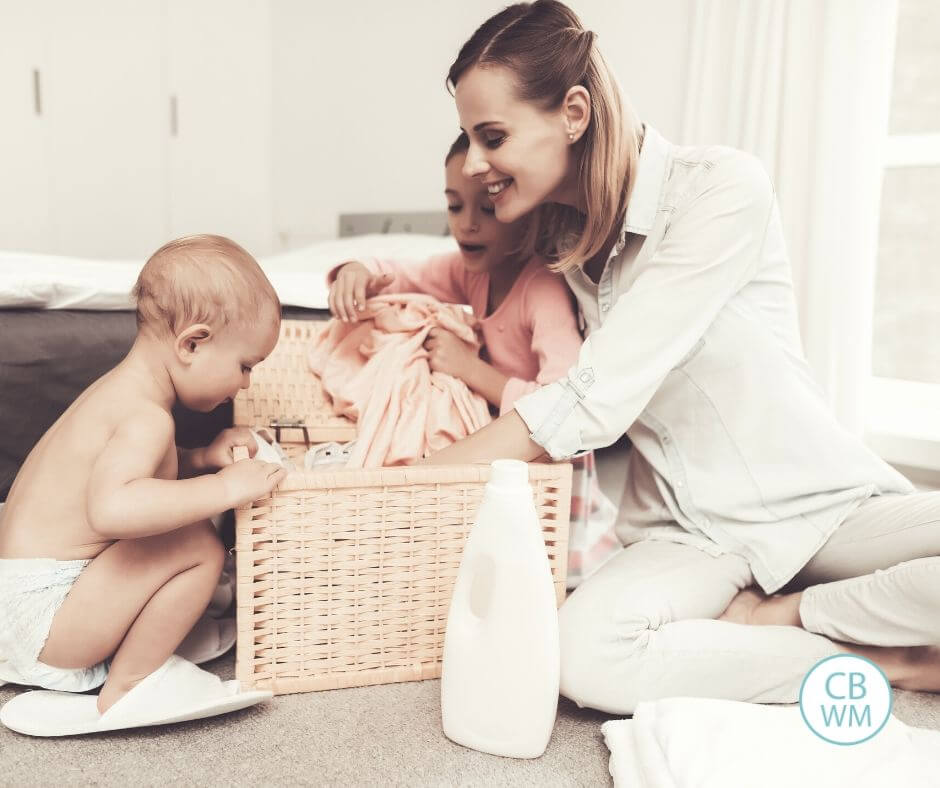 Mom doing chores with two kids