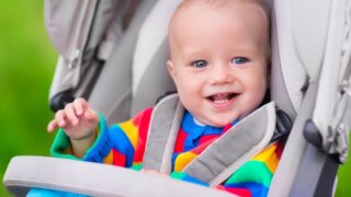 Baby happily sitting in the stroller