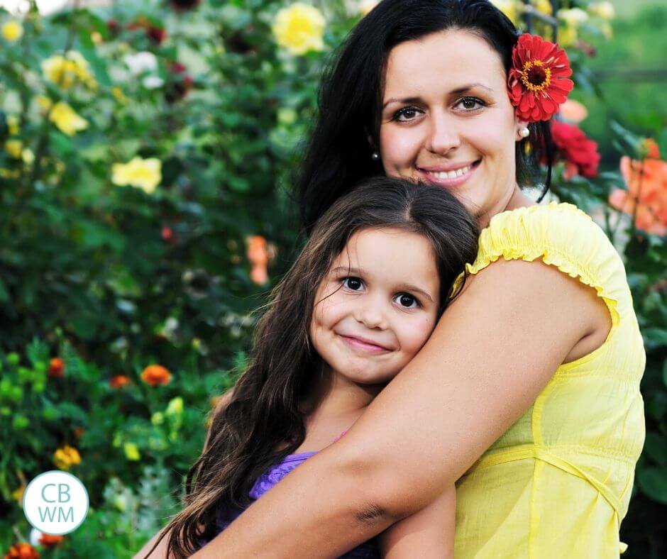 Mom and daughter happily smiling for the camera