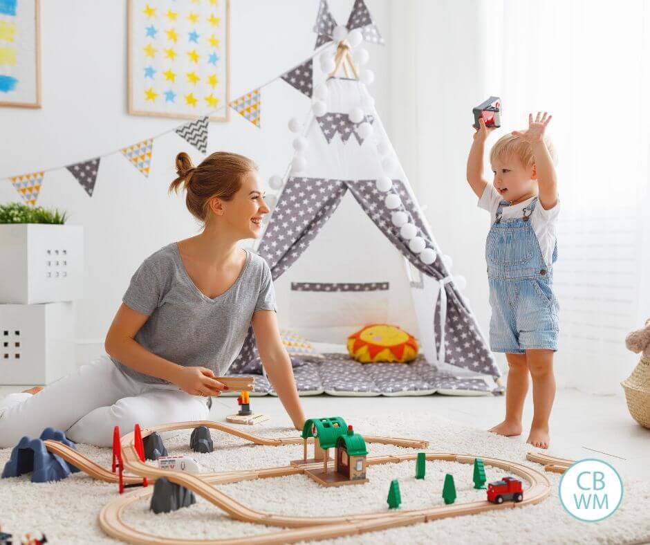 Mom and preschooler playing with trains