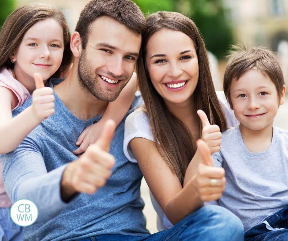 Family of four smiling for the camera