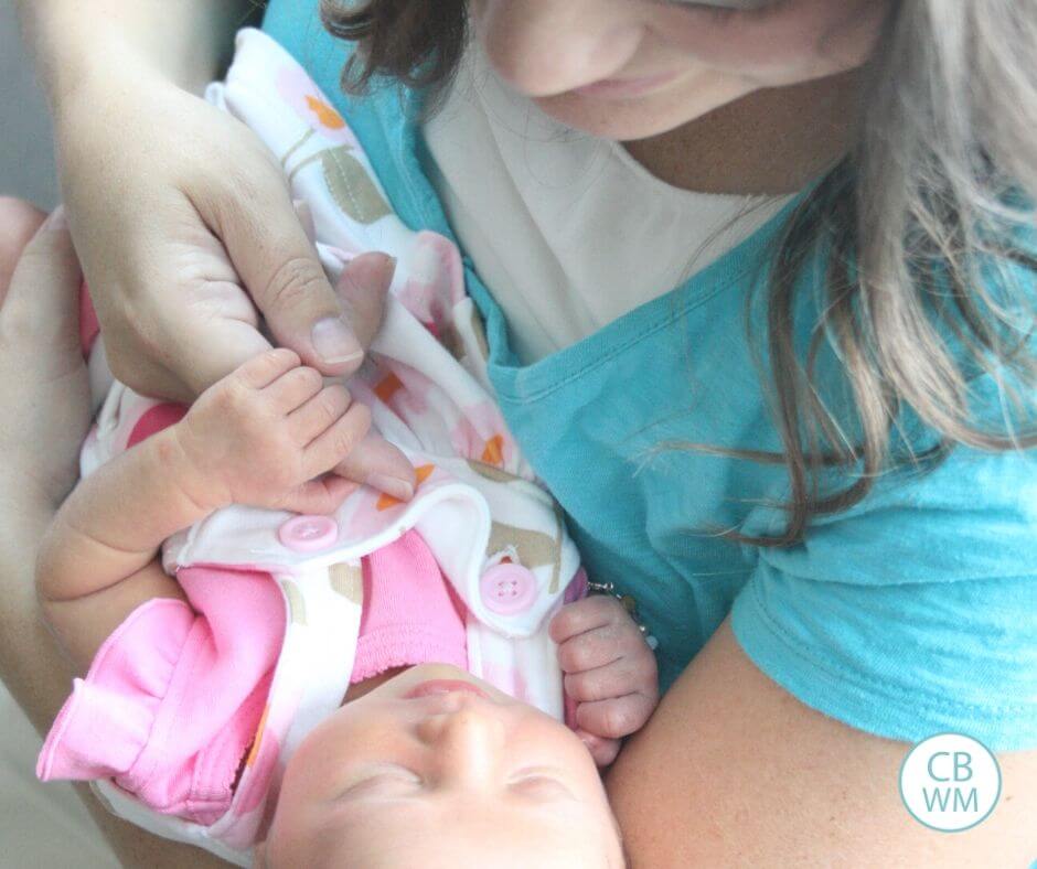 Feed sleepy baby hero image. Mom and newborn baby.