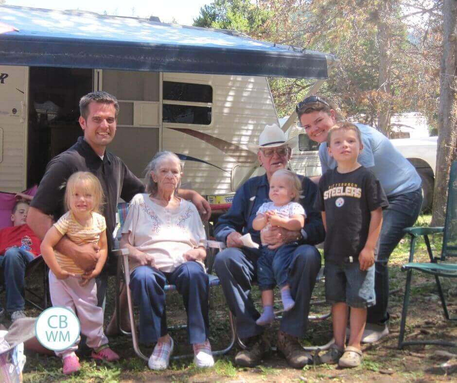 family in front of camper