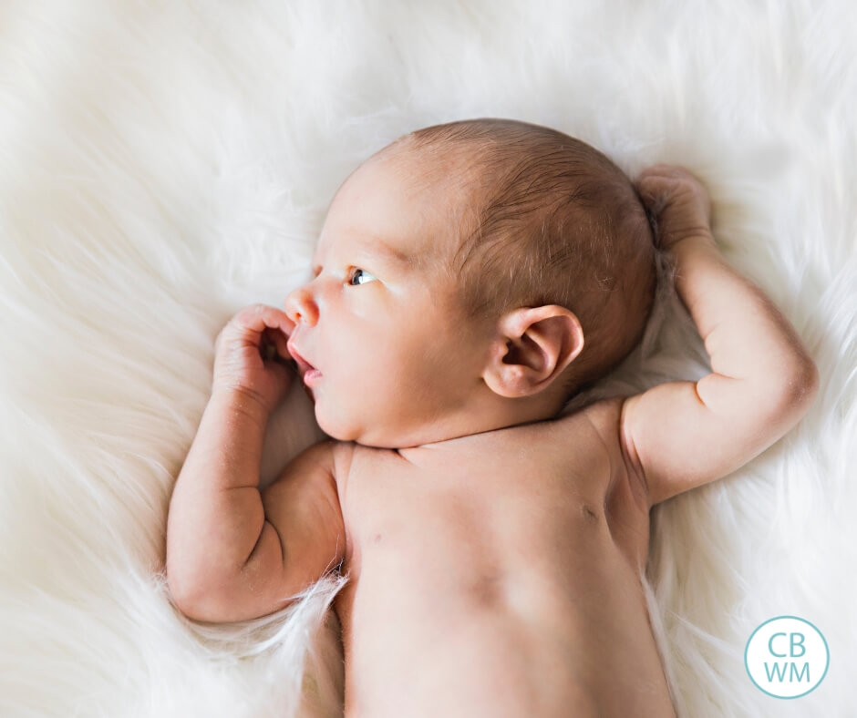 Newborn baby lying on a white blanket