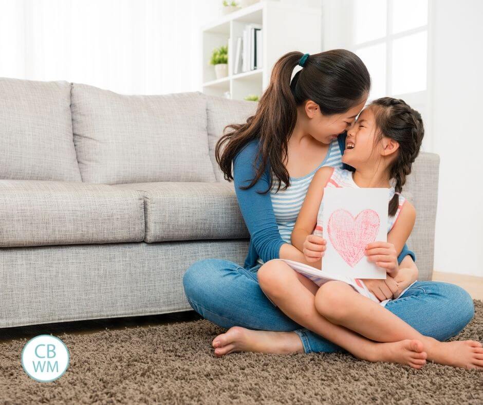 Mom and daughter cuddling on the floor