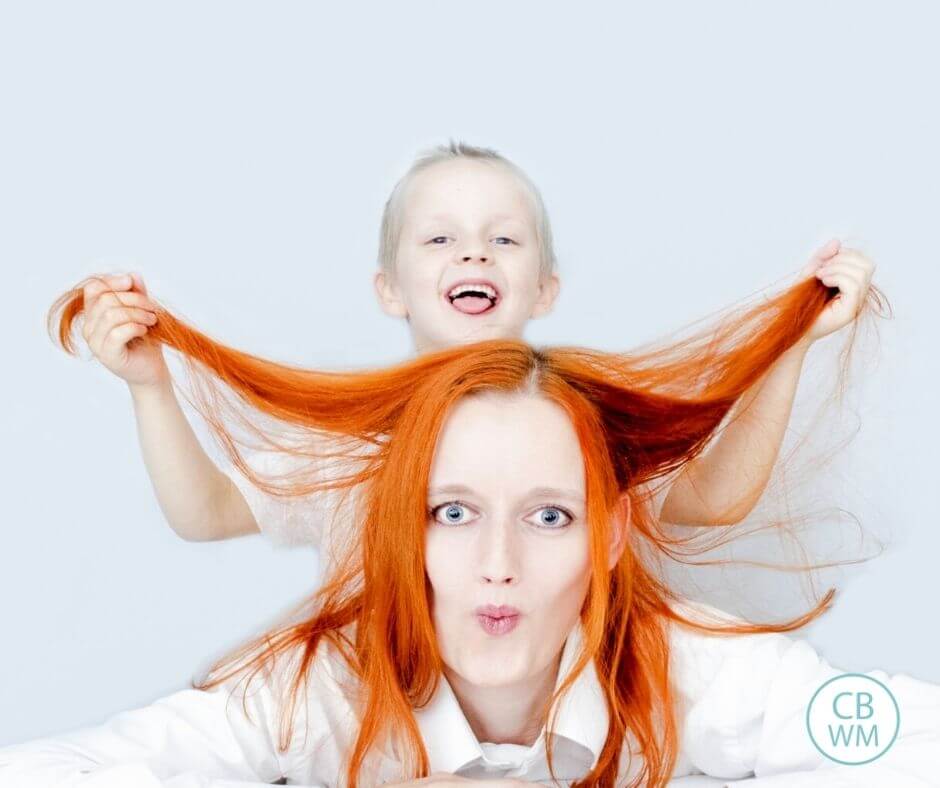 Mom and child pulling on her hair